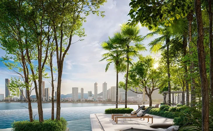 AVÉA pool deck with sun loungers among tropical gardens and the sea beyond, artist's impression